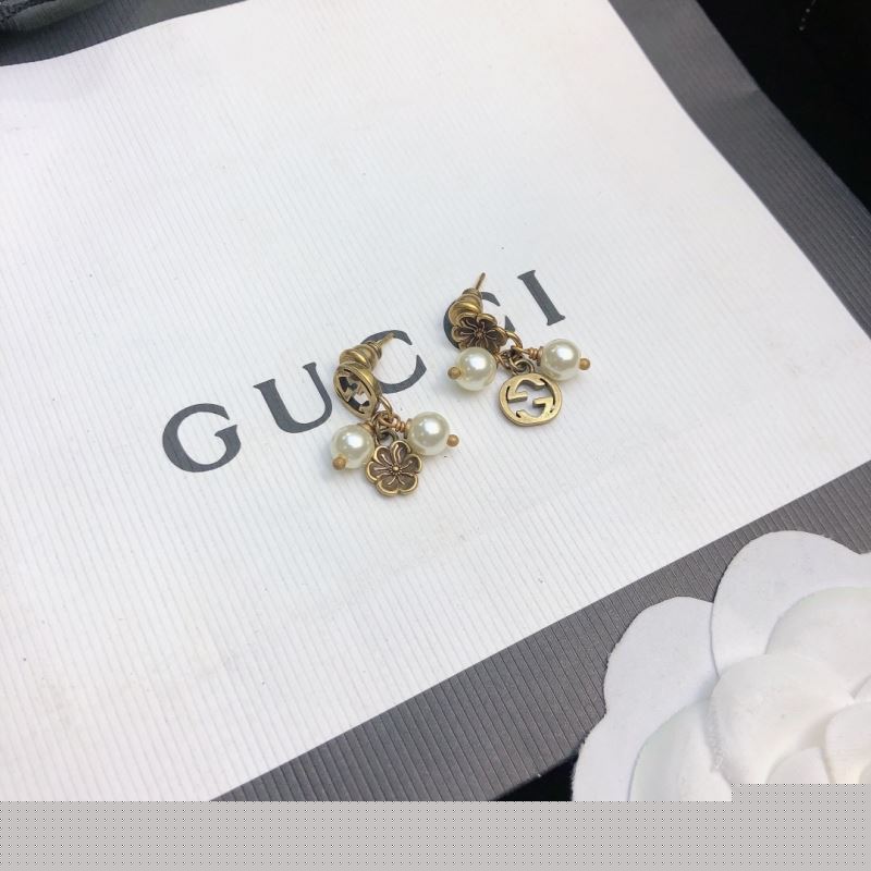 G*u*i earrings